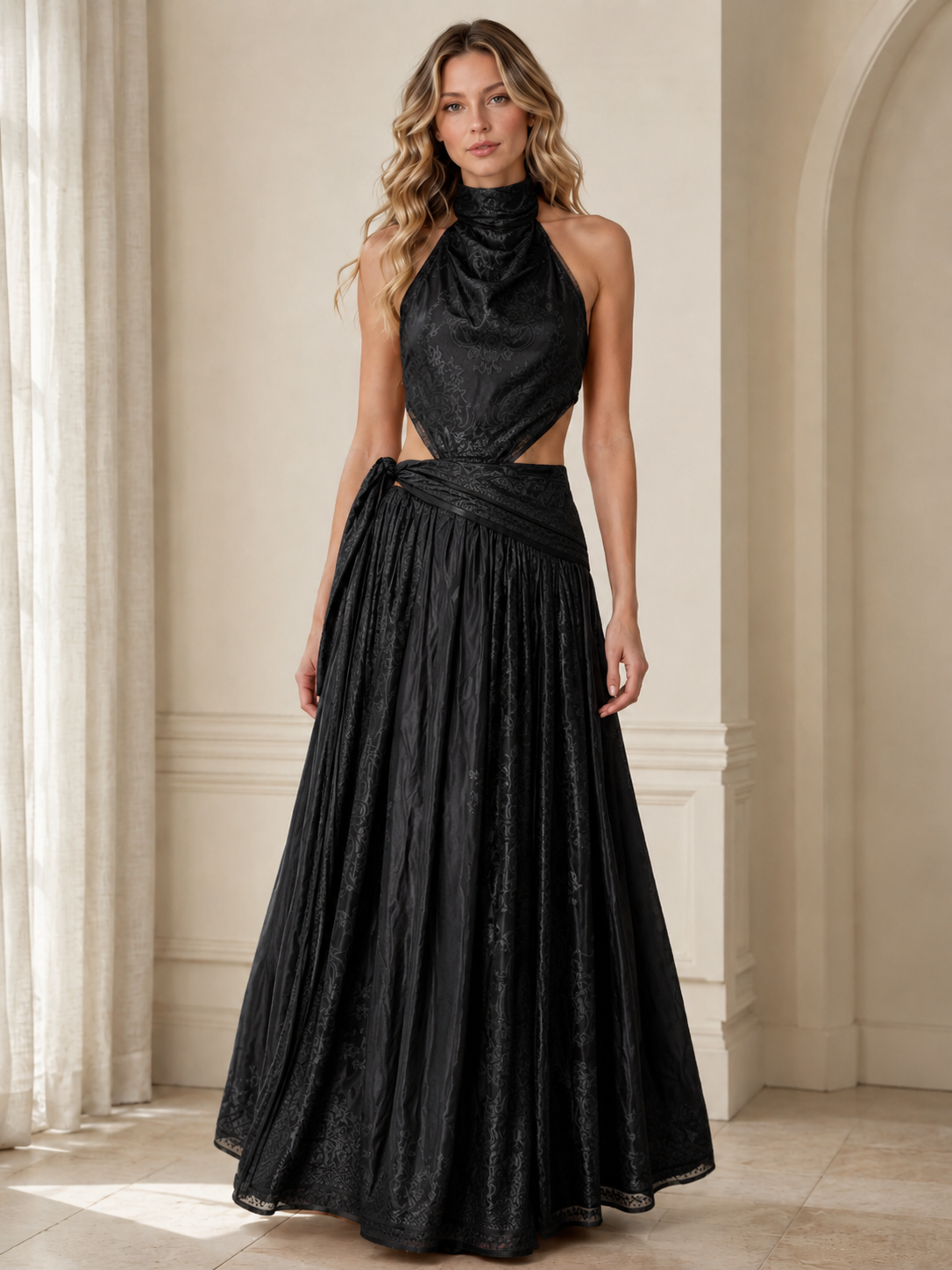 Front view of black halter cutout maxi dress with flowing floor-length silhouette