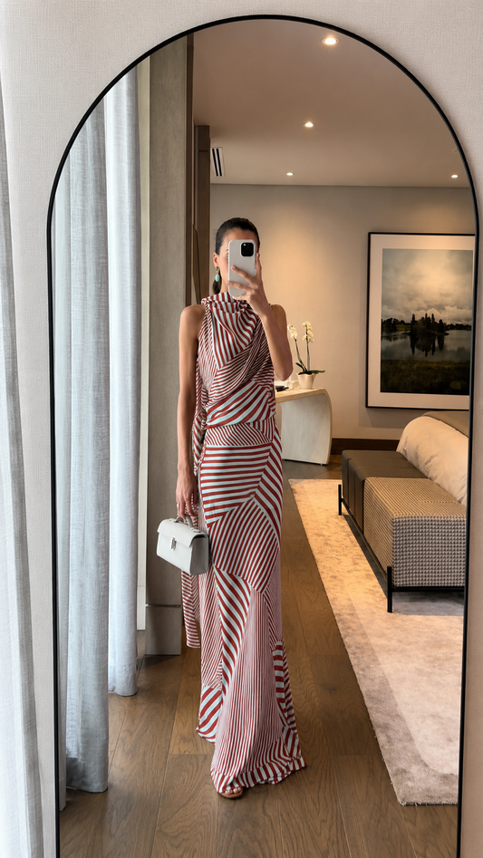 Full-length view of red striped draped halter maxi dress