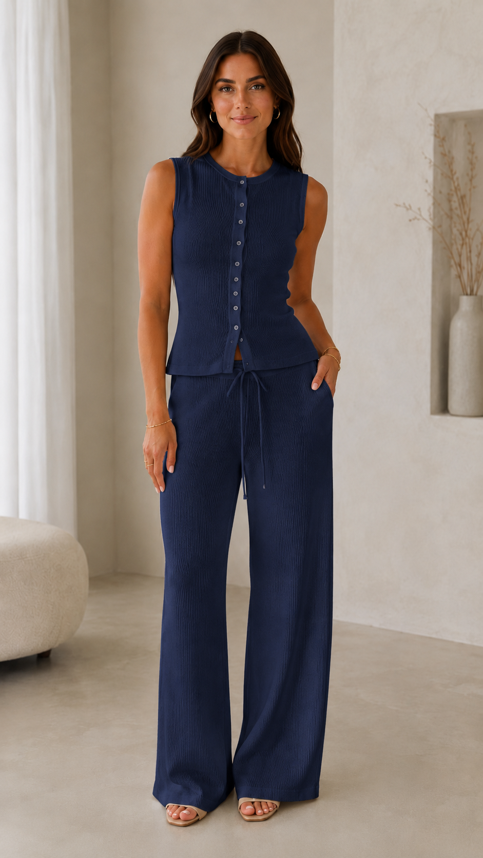 Model wearing a navy ribbed sleeveless button-front top with matching wide-leg drawstring pants