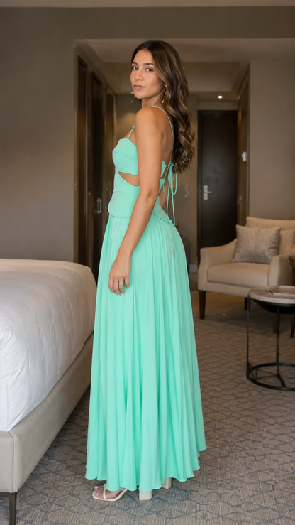 Side view of mint pleated maxi dress with waist cutout and tie-back detail