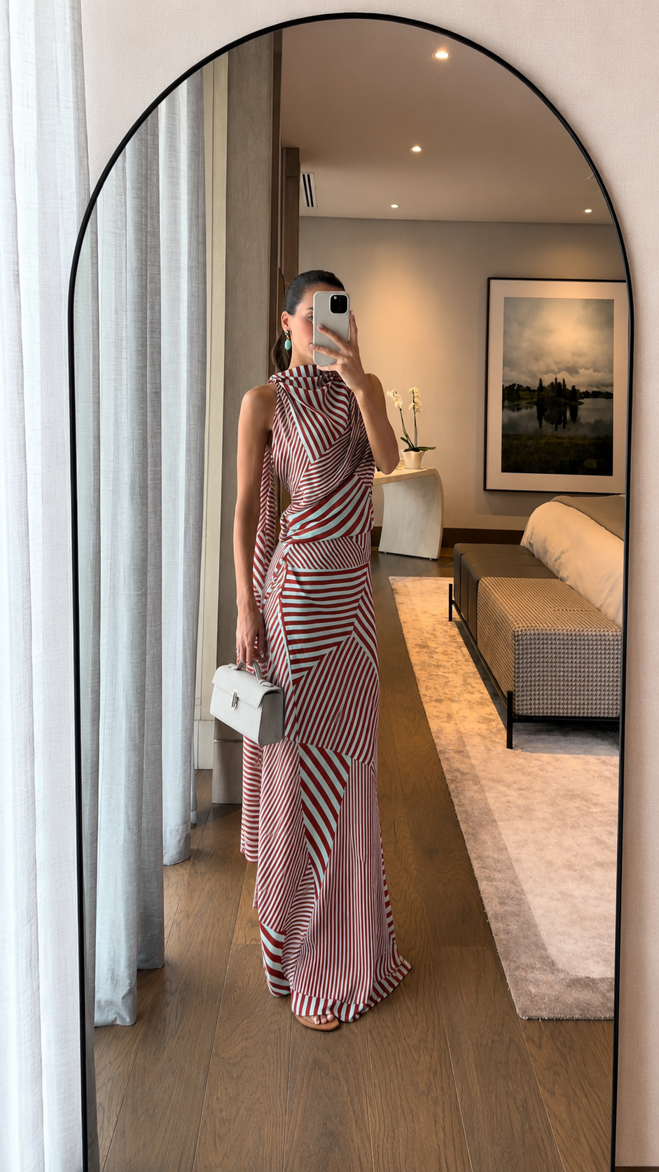 Front view of red striped sleeveless maxi dress with wrap-style draping