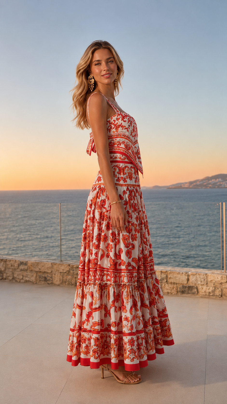 Side view of red and white printed sleeveless maxi dress with flowing skirt