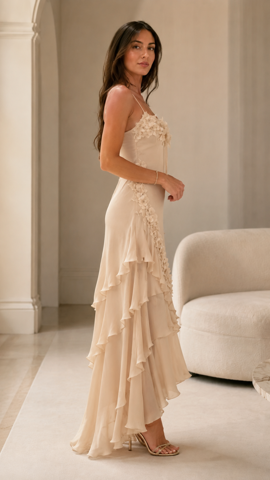 Side view of champagne floral appliqué slip-style maxi dress with cascading ruffles