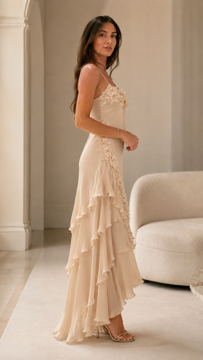 Side view of champagne floral appliqué slip-style maxi dress with cascading ruffles