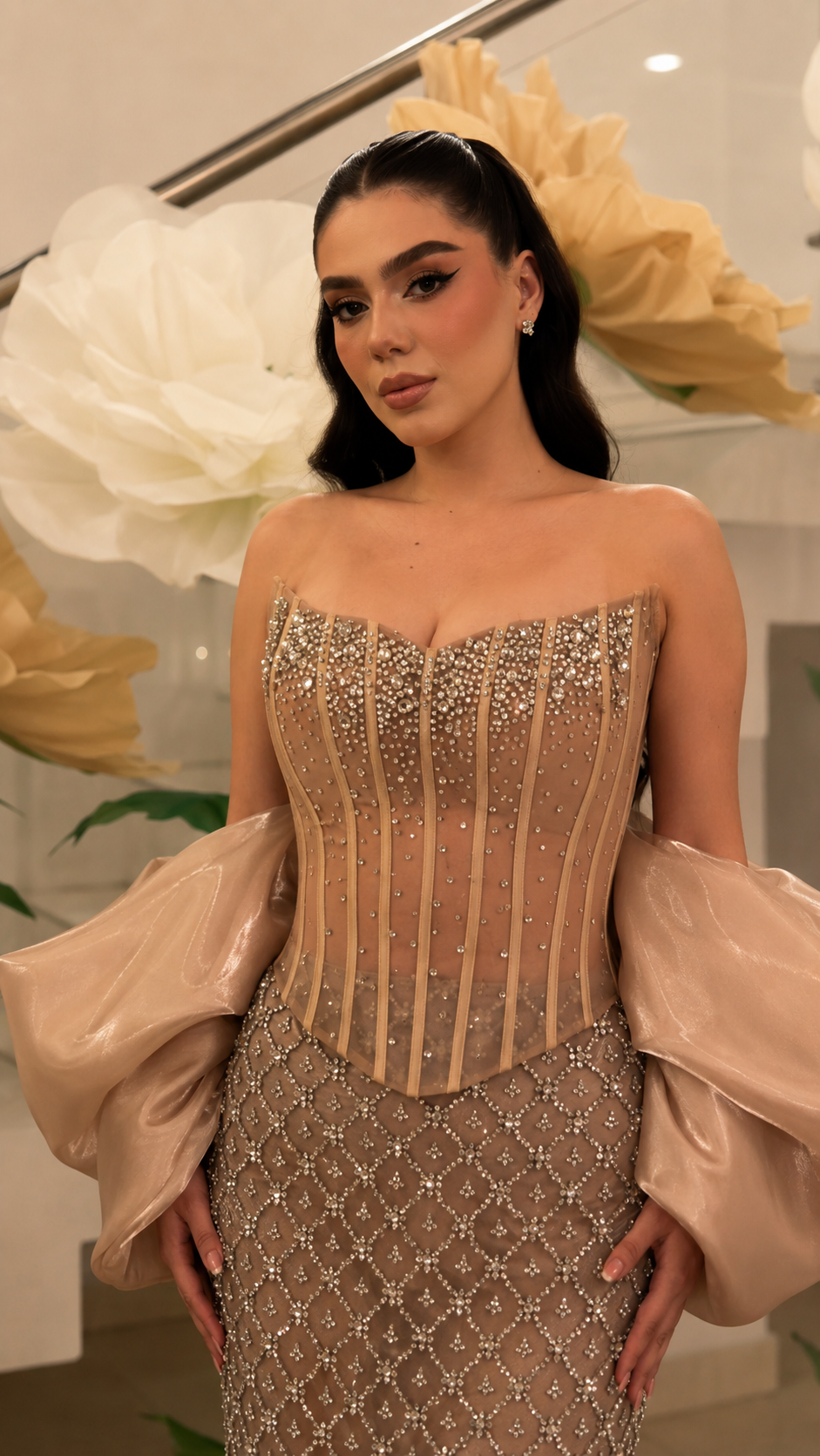 Close-up of champagne-toned corset-style strapless bodice with bead embellishment