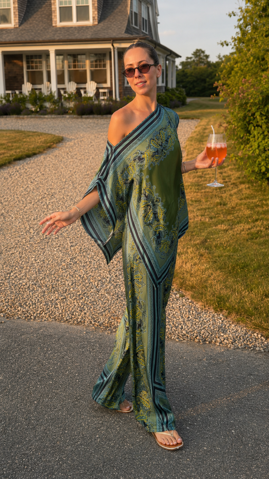 Model wearing teal printed asymmetrical poncho top and matching wide leg pants full outfit view