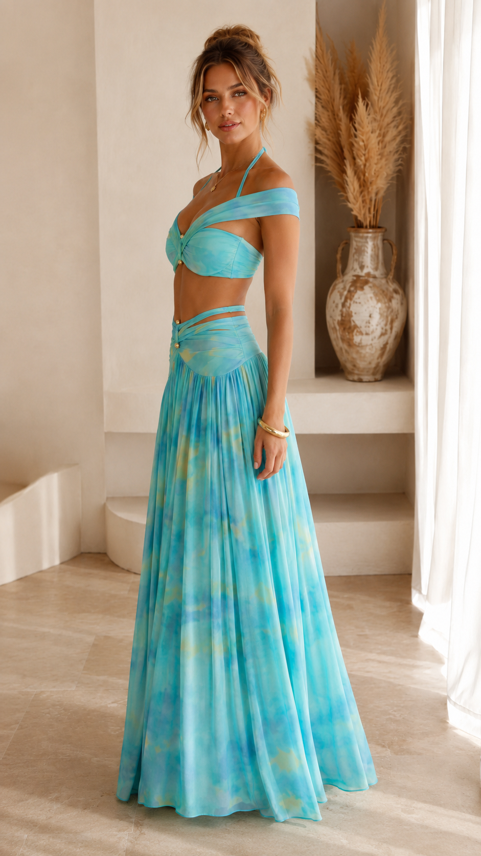 Side view of aqua two-piece maxi skirt set with twisted off-shoulder top and draped skirt