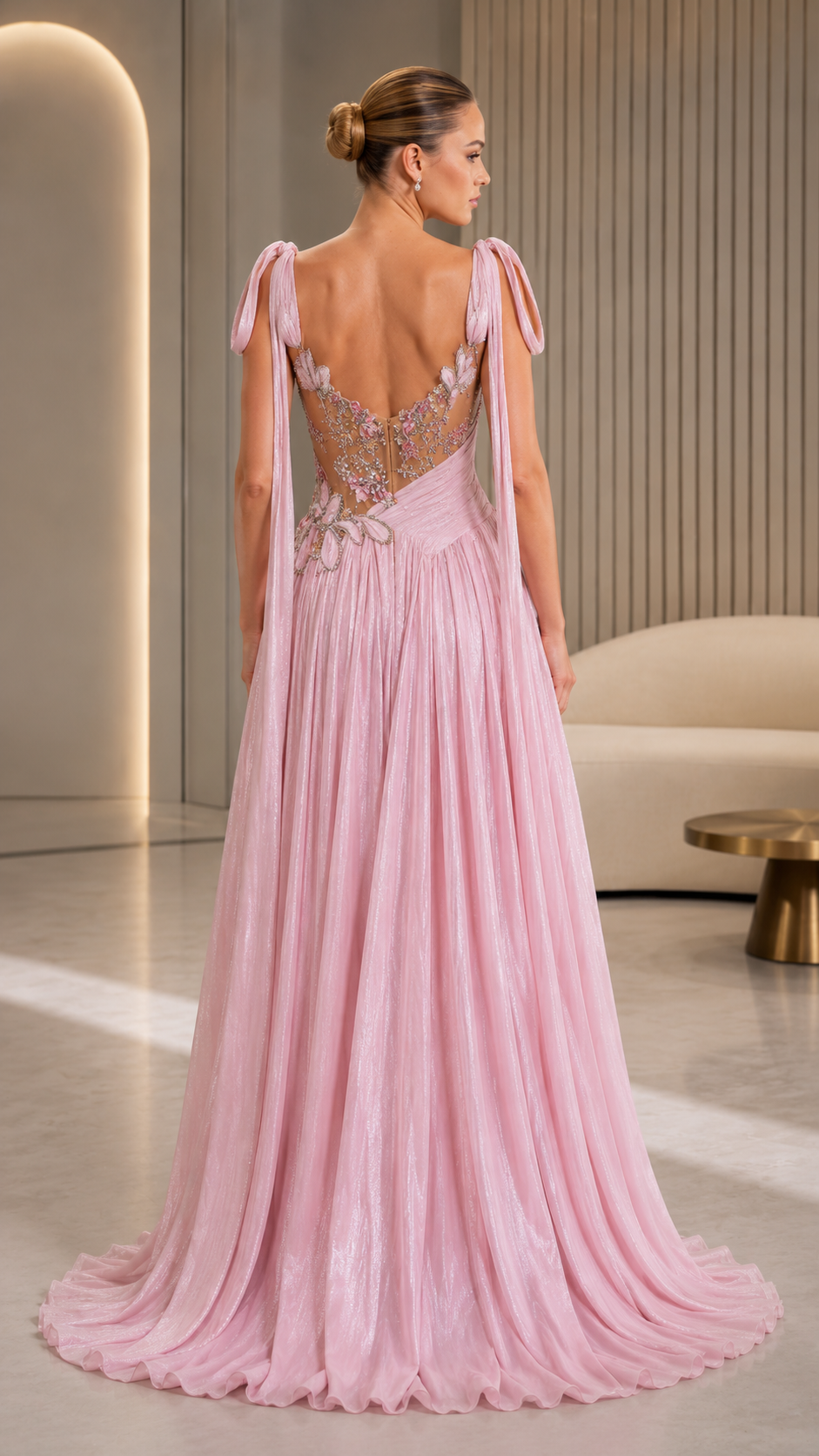 Blush pink evening gown back view with open back and flowing floor-length skirt