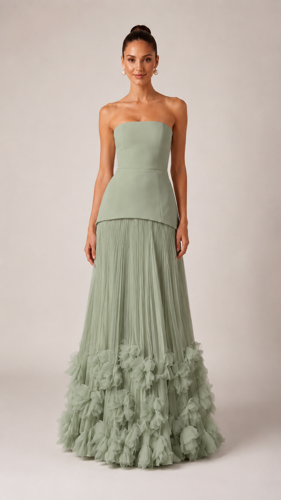 Front view of sage strapless pleated maxi gown with layered waist and textured hem