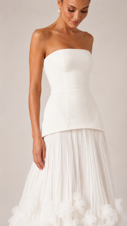 Close-up of ivory strapless bodice and upper pleated skirt detail