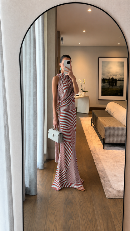 Full-body view of red striped slim-fit maxi dress with white handbag