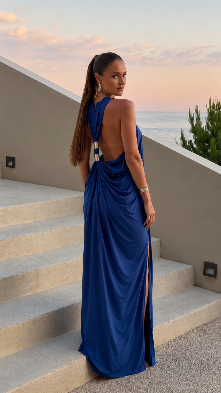 Royal blue open back maxi dress with gathered back detail and slit, angled back view