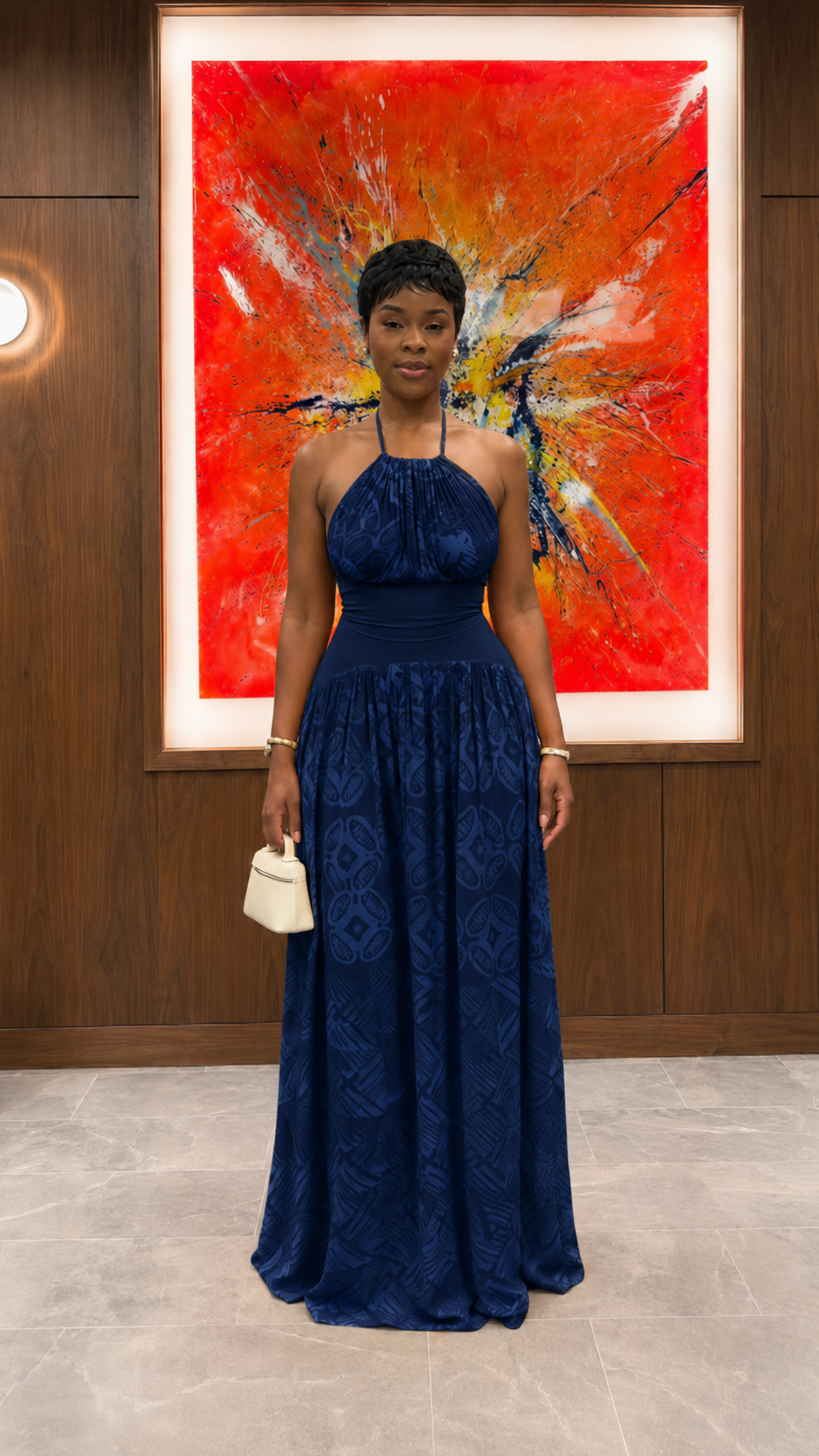 Woman wearing navy halter neck textured maxi dress with full-length skirt front view