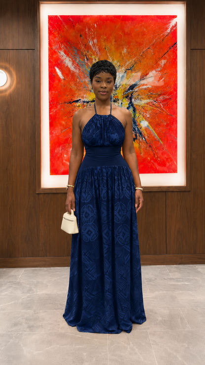Woman wearing navy halter neck textured maxi dress with full-length skirt front view