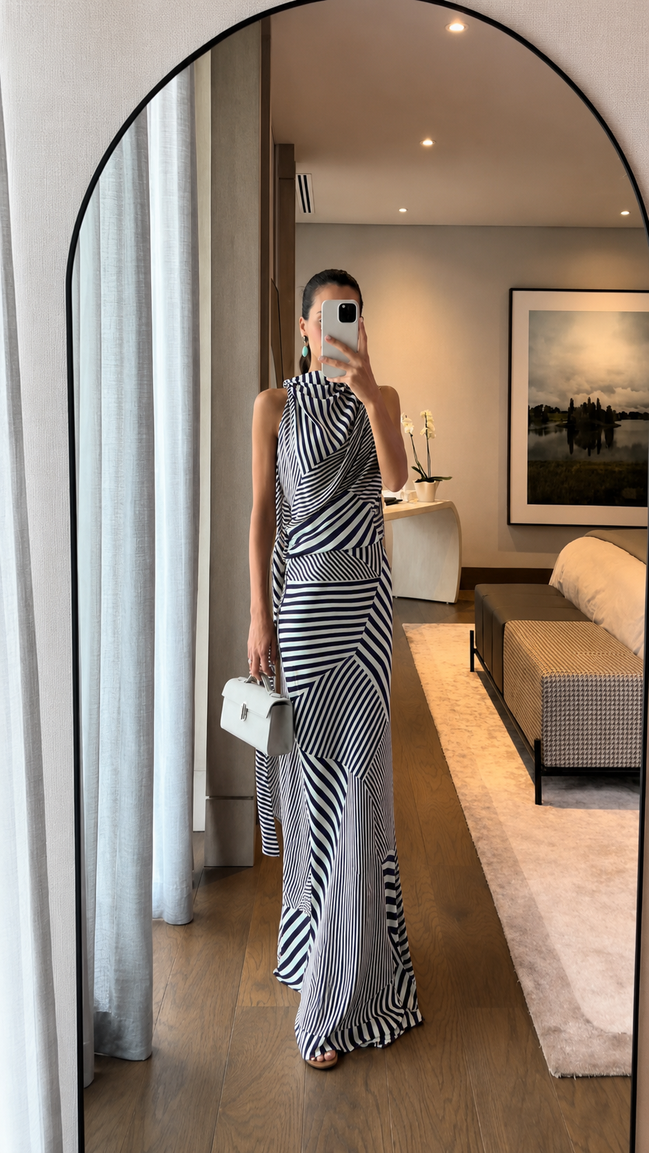 Full-length view of black striped draped halter maxi dress