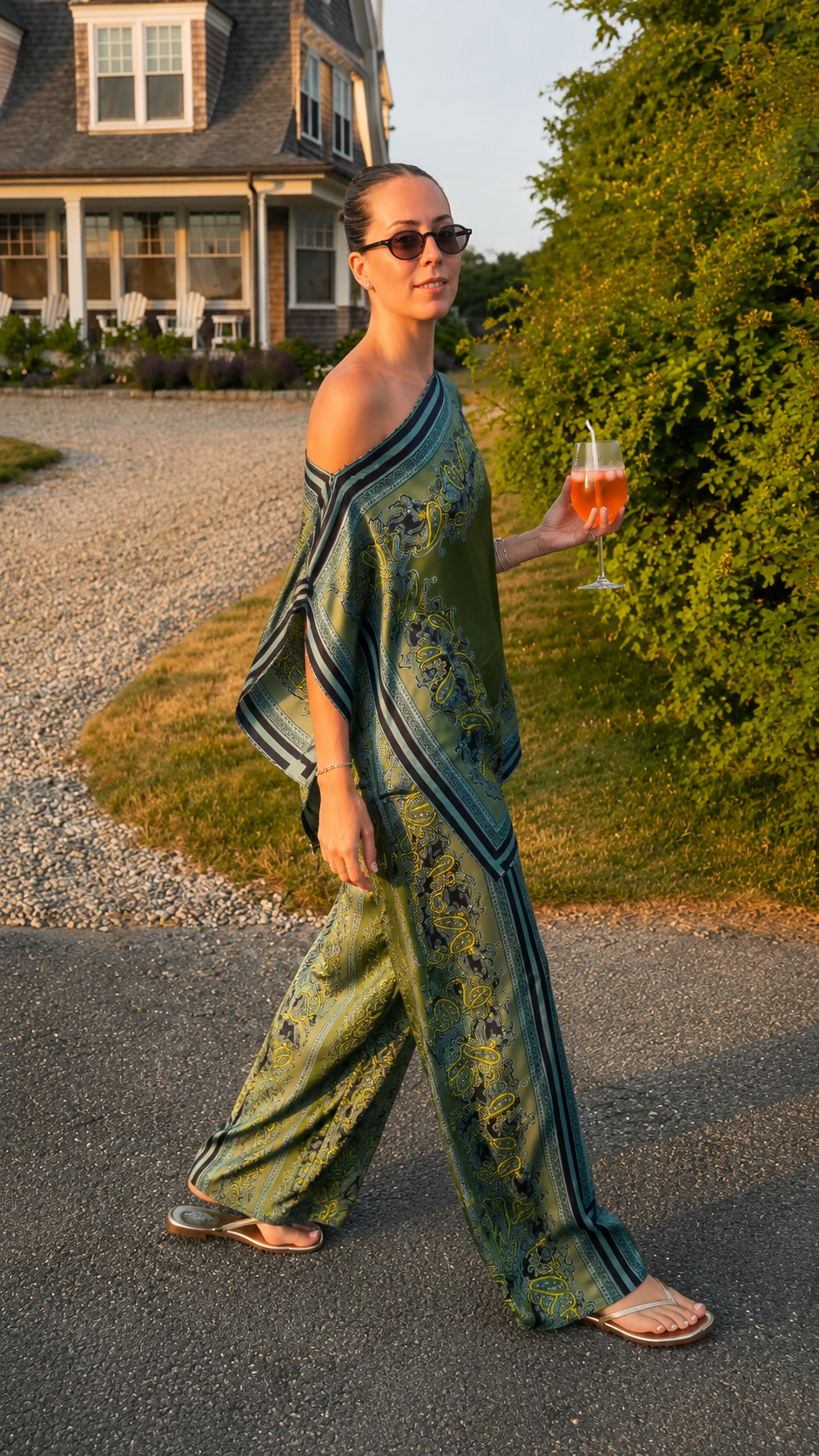 Model wearing olive green printed two-piece wide leg pants set walking outdoors