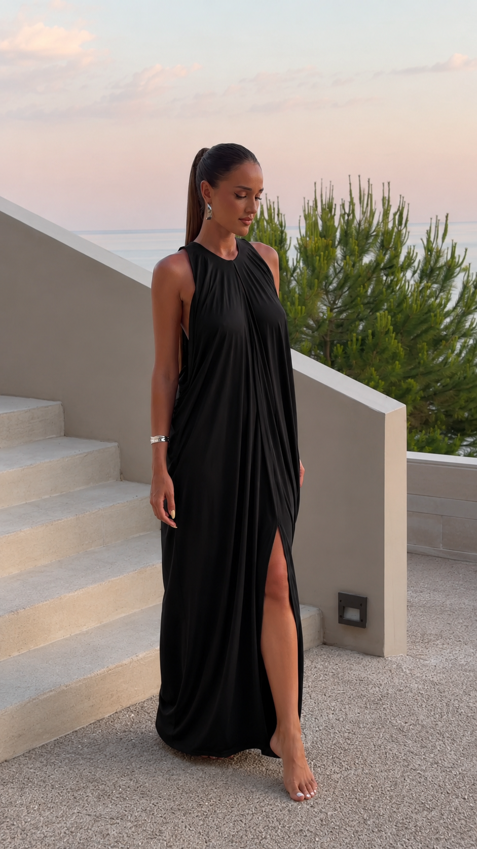 Black halter maxi dress with soft drape and high front slit