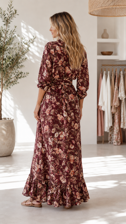 Burgundy floral maxi dress with ruffle hem shown from the back side
