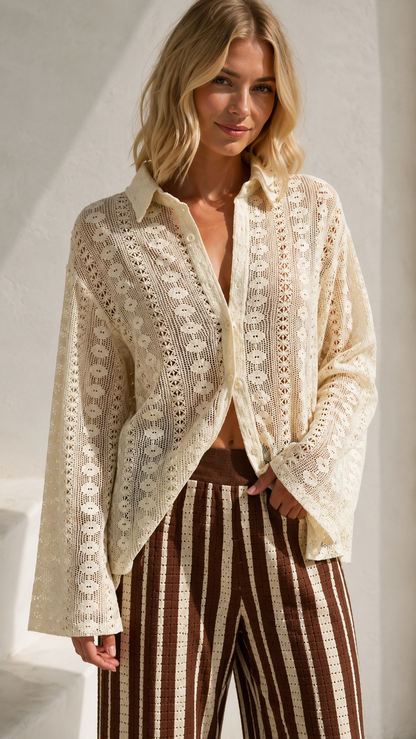 Close-up of cream lace-look collared shirt and striped wide leg pants