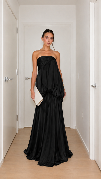 Front view of black strapless draped bubble waist maxi gown