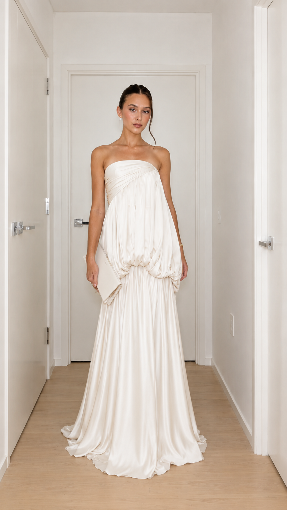 Front view of ivory strapless draped bubble waist maxi gown