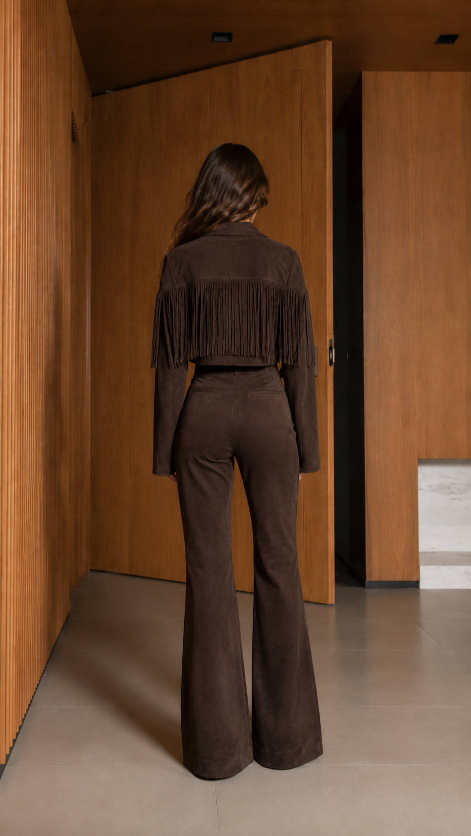 Back view of chocolate brown fringe jacket and flare pants showing back fringe detail