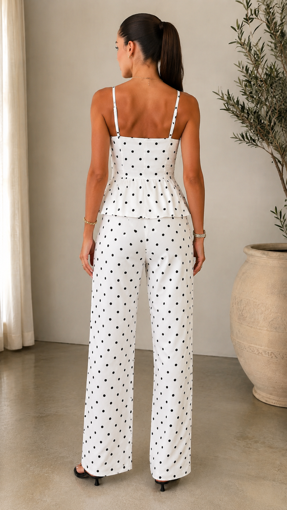 Back view of white polka dot peplum cami top and wide leg pants set