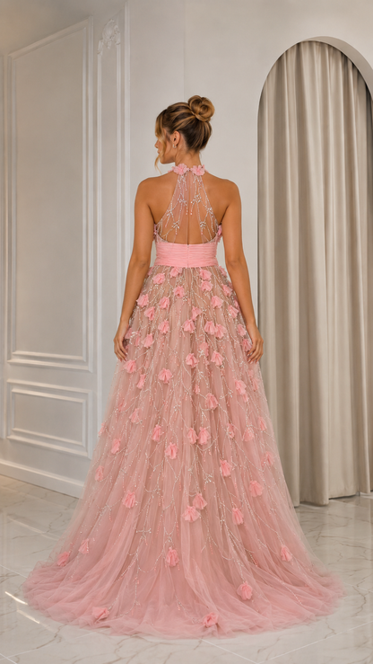 Back view of blush pink halter gown with open back and sweeping tulle skirt