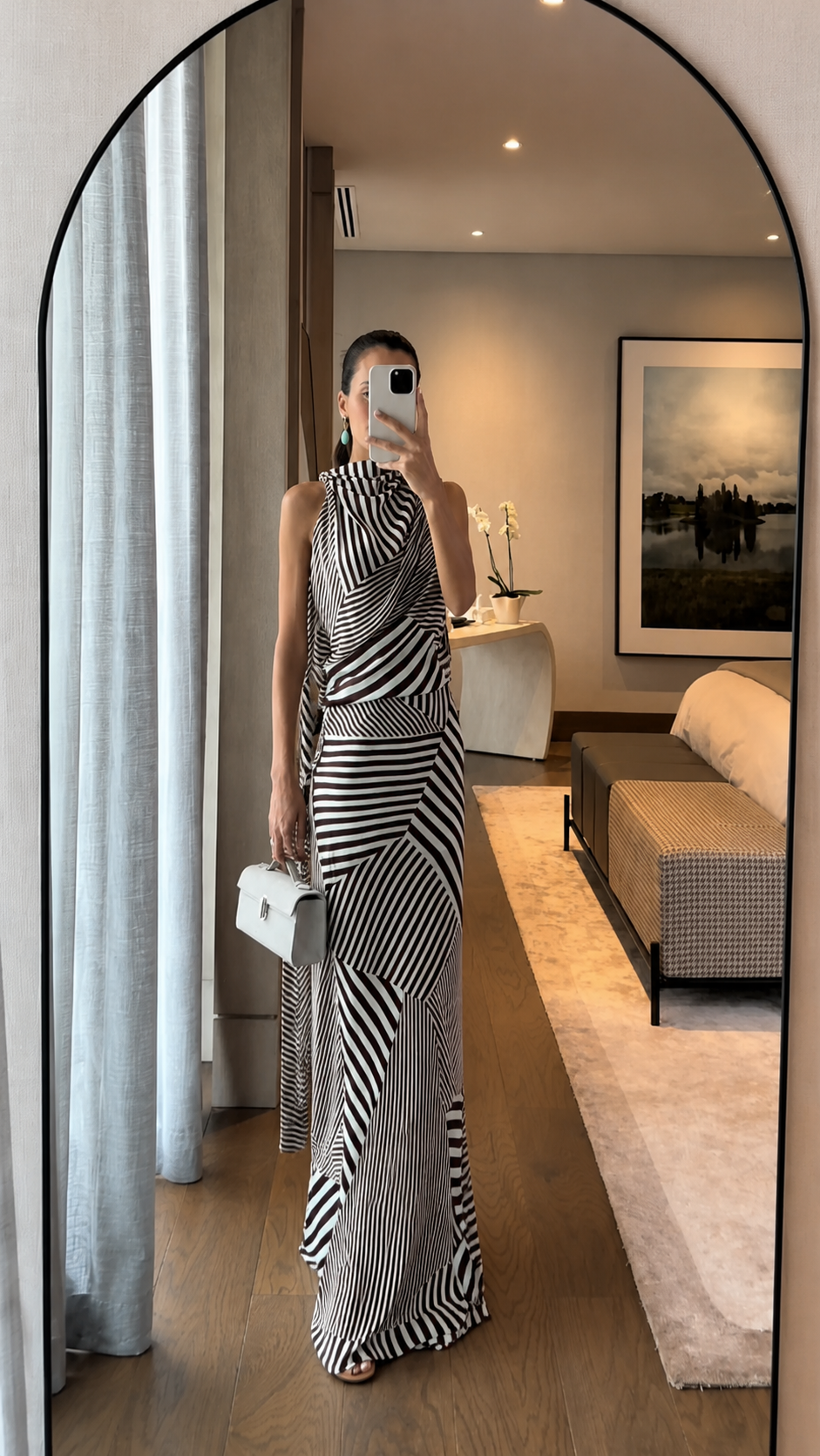 Full-length view of black striped high-neck maxi dress with directional pattern