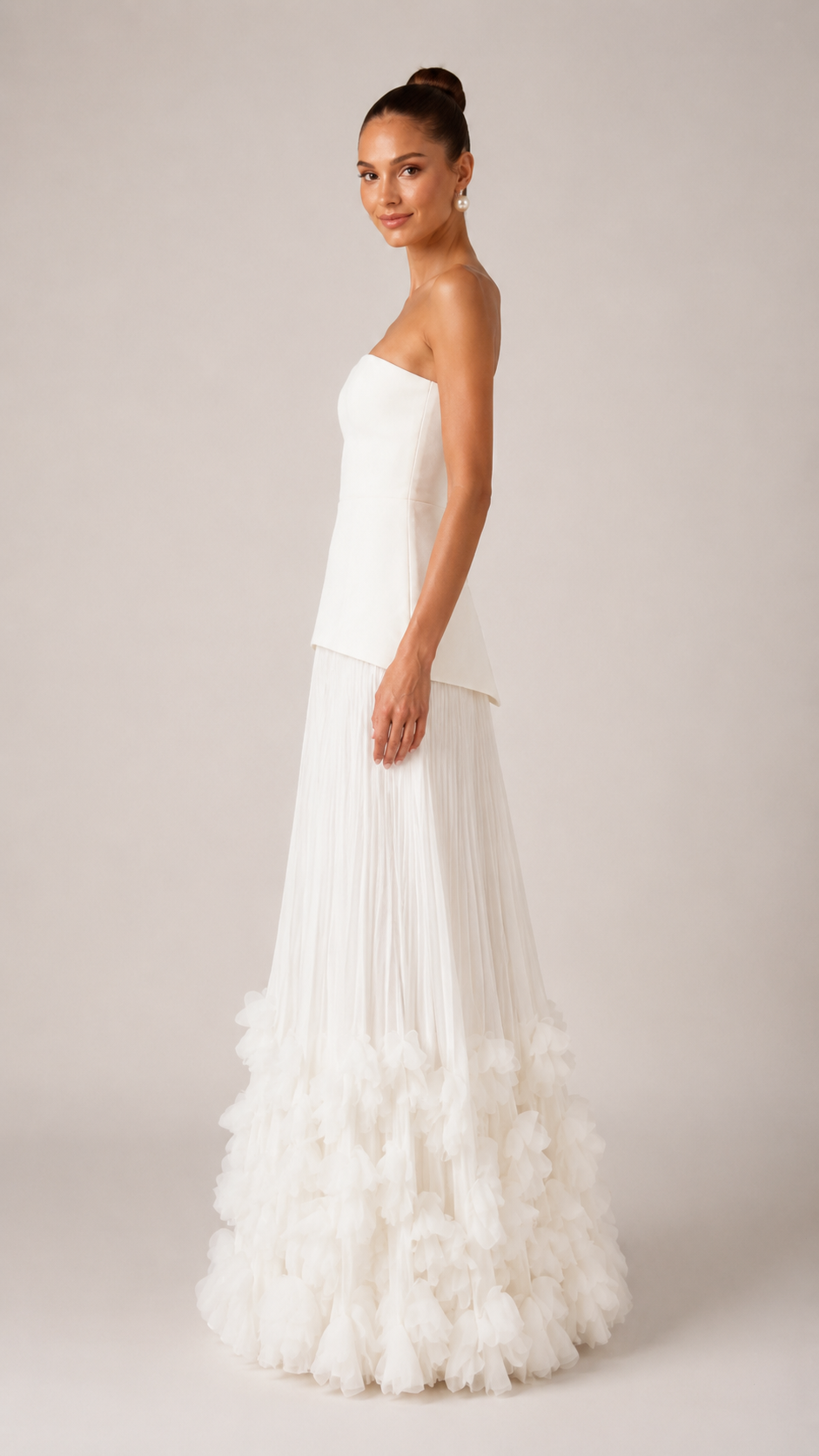 Side view of ivory strapless maxi gown showing slim bodice and flowing silhouette