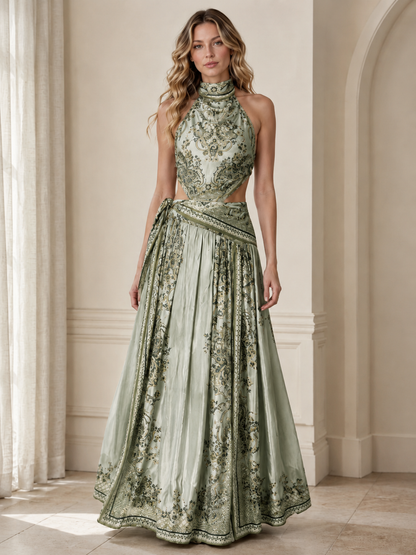 Front view of sage green halter maxi dress with ornate print and wrap waist sash