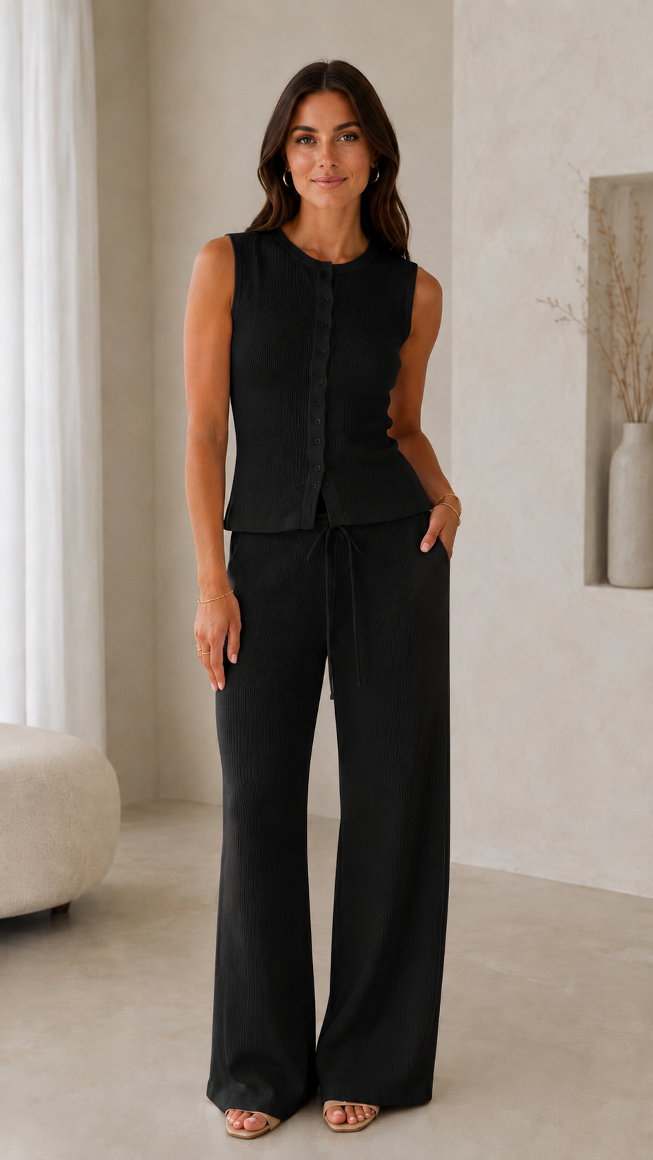 Model wearing a black ribbed sleeveless button-front top with matching wide-leg drawstring pants