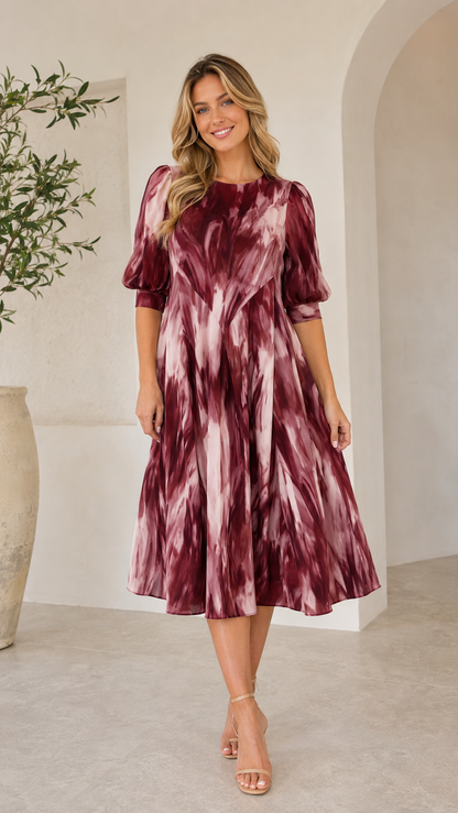 Front view of burgundy tie-dye midi dress with round neck and midi length