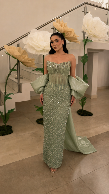 Sage green beaded strapless evening gown with oversized arm drapes and fitted silhouette