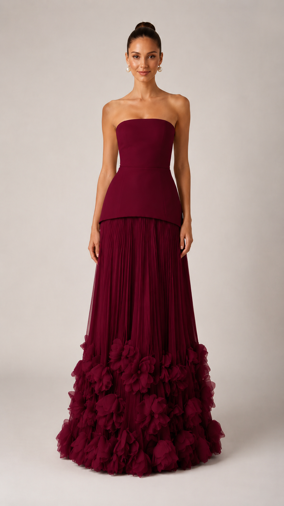 Front view of wine strapless maxi gown with sculpted bodice and dramatic textured hem