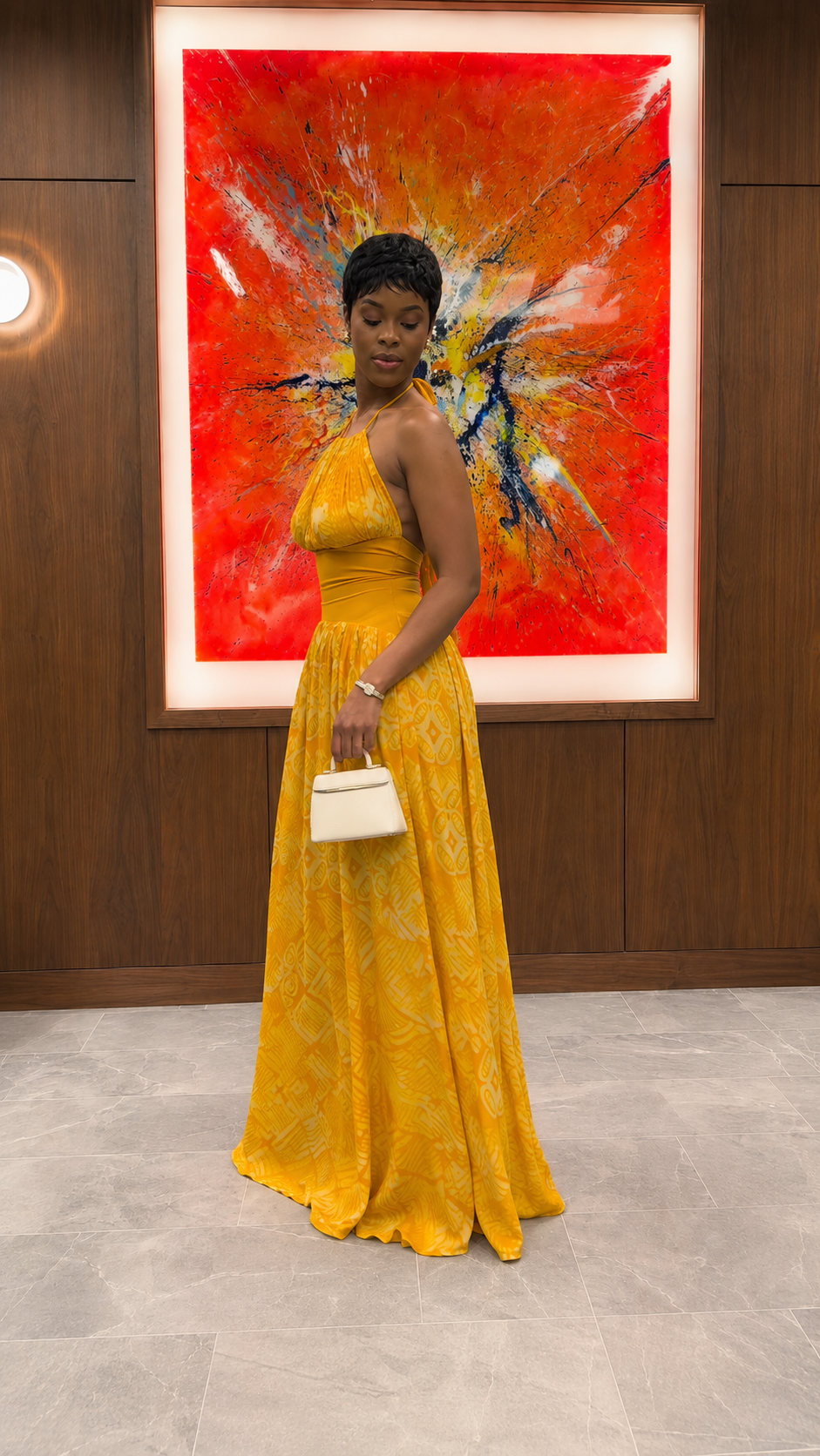 Side view of mustard halter neck textured maxi dress with full skirt drape